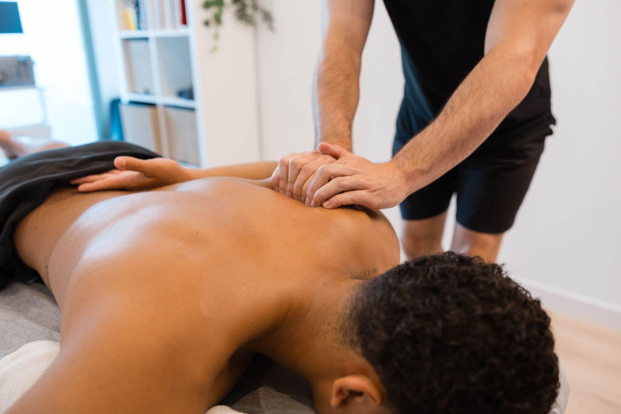 Sports massage therapist working on a client’s back at a private massage studio in Hermosa Beach
