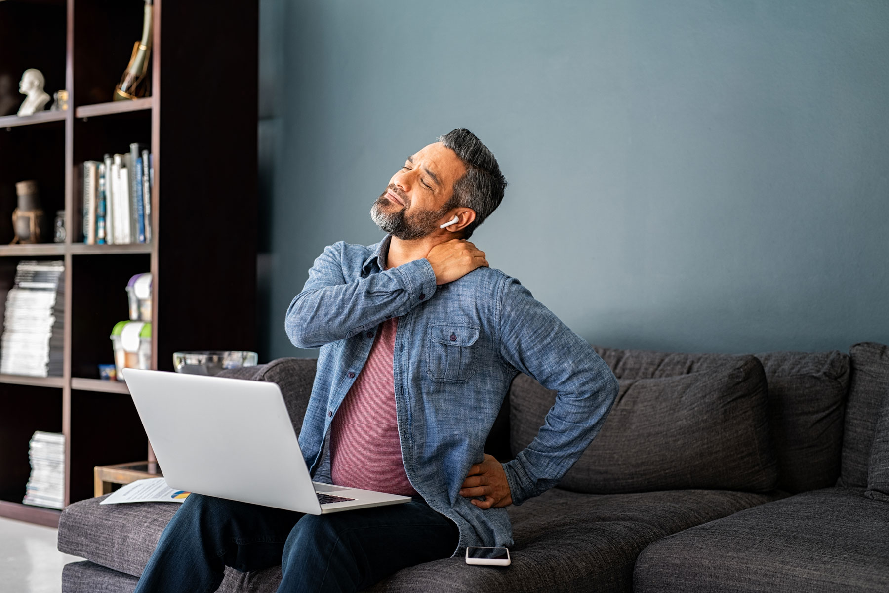 Man experiencing neck and shoulder pain that may benefit from massage therapy in Hermosa Beach